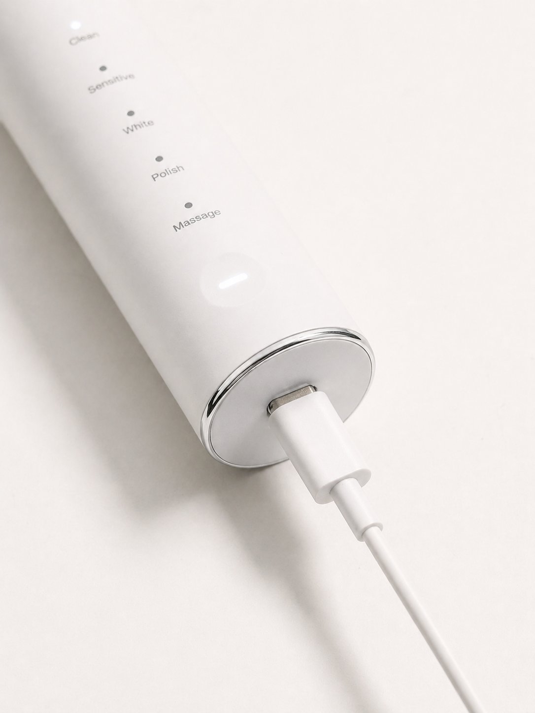 Snosha N2 white electric toothbrush USB-C charging port close-up showing charging connection